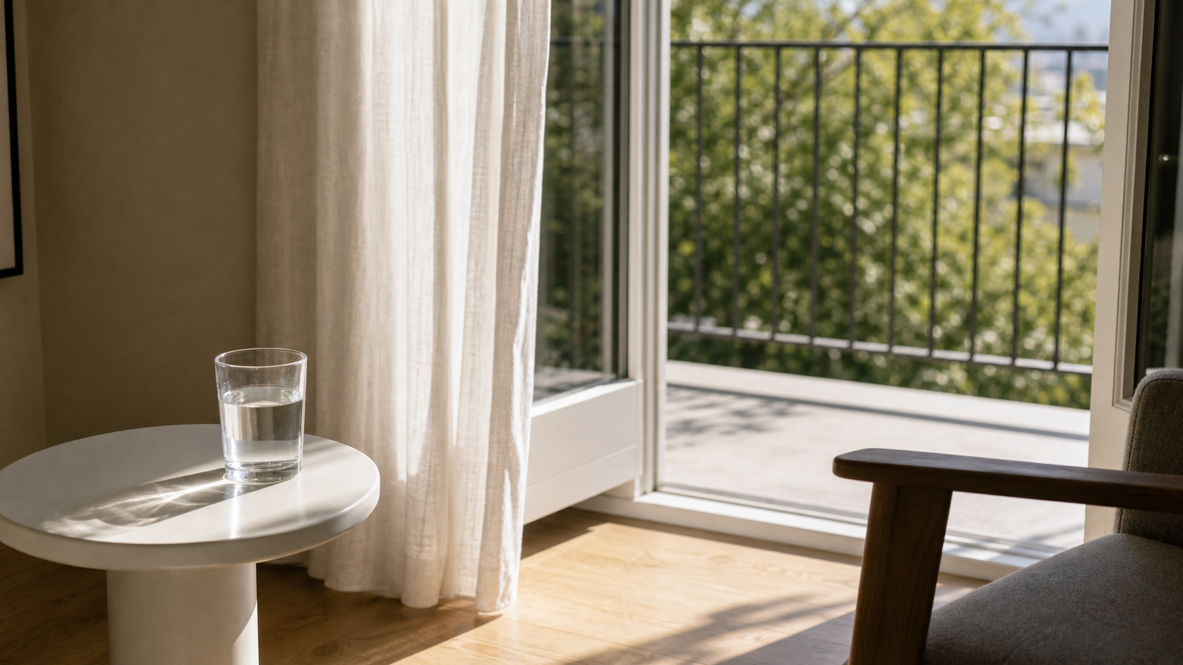 glass of water, white chair, open balcony door
