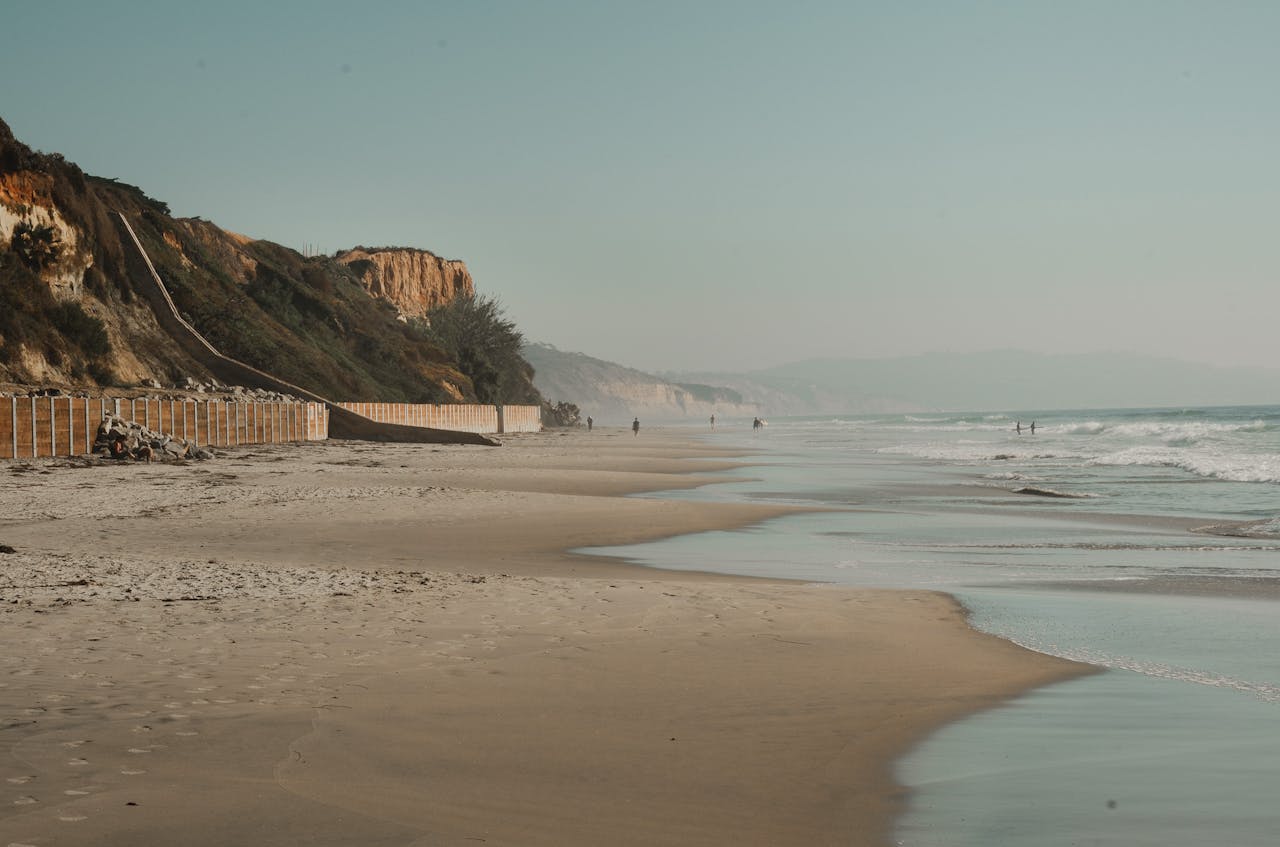 Peaceful California beach scene with stunning cliffs and tranquil ocean waves.